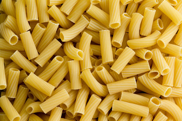 Background texture of dried tubular rigatoni pasta