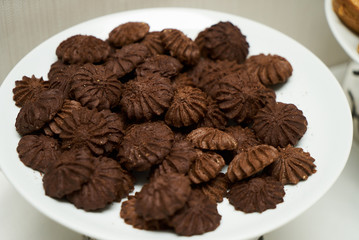 Cookies and sweet biscuits on white plate background, top view 