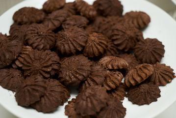 Cookies and sweet biscuits on white plate background, top view 