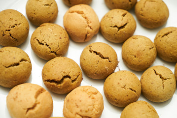 Cookies and sweet biscuits on white plate background, top view 