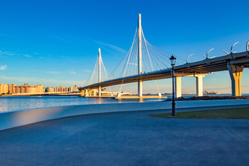 Bridge. Highway. Embankment on the background of the bridge. Highway against the blue sky.