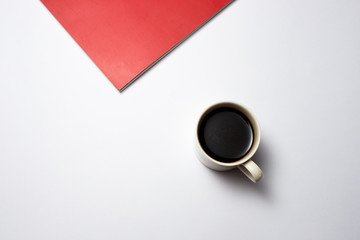 Obraz na płótnie Canvas A cup tea on white background and red book
