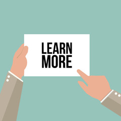 Man showing paper LEARN MORE text