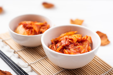 Kimchi cabbage in a bowl with chopsticks, Korean food