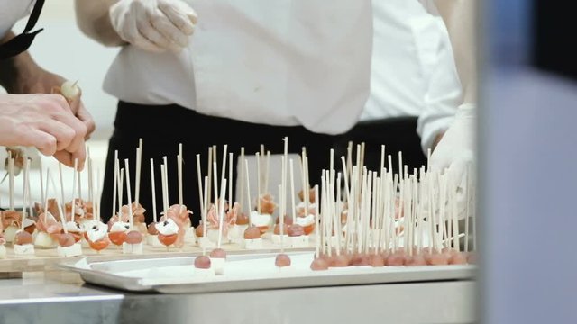 Chef preparing and decorating food, canap&eacute;s and snacks for a buffet table  in restaurant
