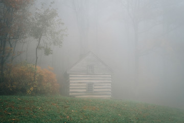 Cabin in fog and autumn color at Peaks of Otter, on the Blue Ridge Parkway in Virginia.