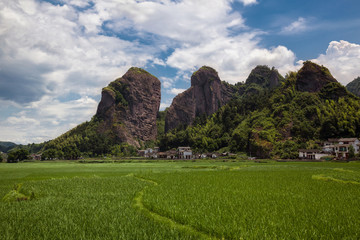 Lang Mountain, Langshan - China National Geopark, Xinning County Hunan province. Unique Danxia Landform, UNESCO Natural World Heritage site. Lush green grass fields and red danxia mountain landforms