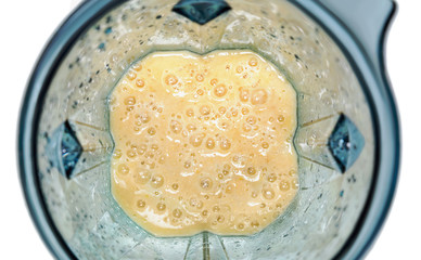 Mango and yogurt smoothie. Smoothie in blender with white backgr