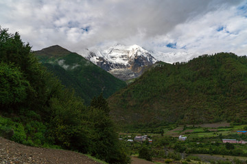 Fototapeta na wymiar The height of the Himalayas with Annapurna II peaking out on a cloudy day