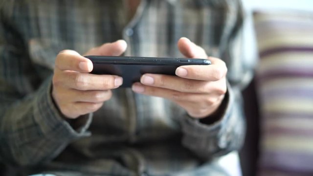 Close up slow-motion men with smartphones playing game