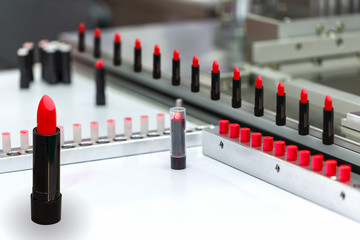 A lipstick vial filling machine in a cosmetics factory.