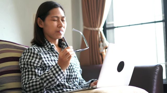 Woman taking off glasses tired of laptop computer work, Suffering from eye strain tension or blurry vision problem concept