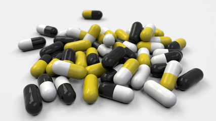 Pile of black, white and yellow medicine capsules