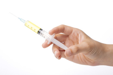 hand hold a yellow syringe isolated white.