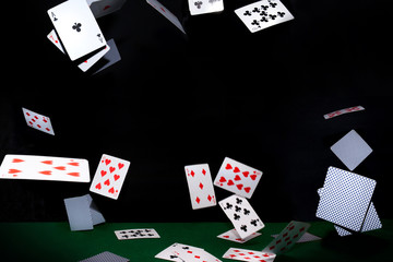 Flying poker cards on black background. Casino concept.
