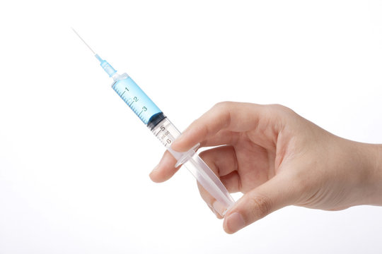 Hand Hold A Syringe Isolated White.