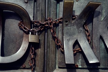 Lock and chain on a metal door.