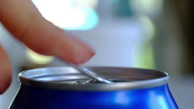 Close up of womans hand opening a can