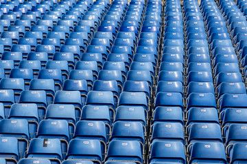 Blue plastic chairs with numbers on the tribune
