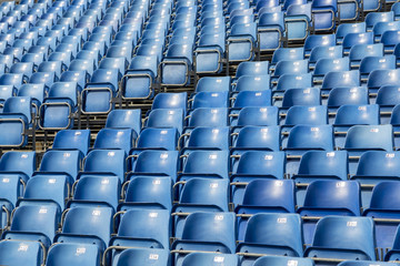 Blue plastic chairs with numbers on the tribune