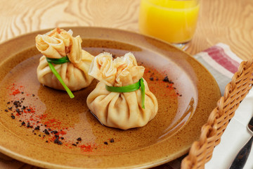 Stuffed pancake bags tied with green close up