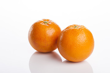 two fresh oranges close up isolated white.