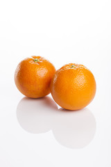 two fresh oranges close up isolated white.