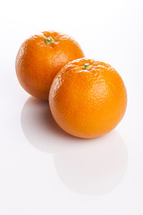 two fresh oranges close up isolated white.