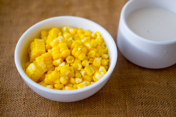 Scattered boiled grain of yellow ripe corn