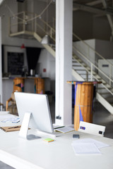 Naklejka premium Workplace in modern office with computer monitor and supplies on desk
