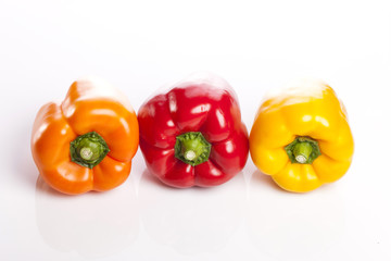 three colored paprika isolated white.