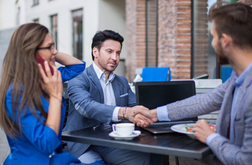 business woman talking on the phone in a street cafe