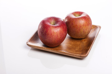 fresh apple on the wood tray isolated white.