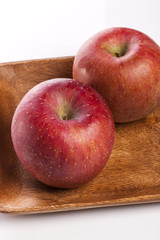 Fototapeta na wymiar fresh apple on the wood tray isolated white.