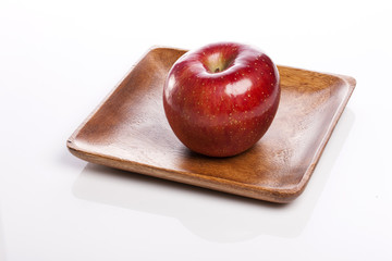 fresh apple on the wood tray isolated white.