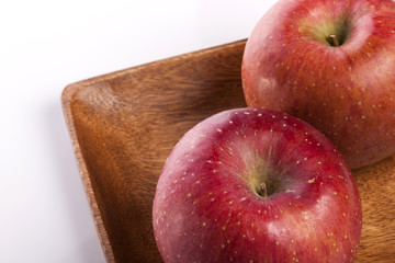 fresh apple on the wood tray isolated white.