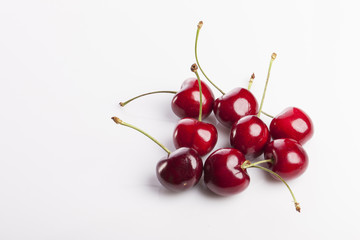 Fototapeta na wymiar fresh red cherry on the white ceramic isolated white