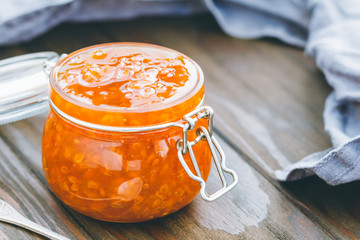 Glass jar with cloudberry jam. Nordic cuisine.