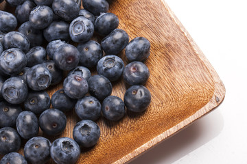 many blue berry on the wood table, whitebackground.