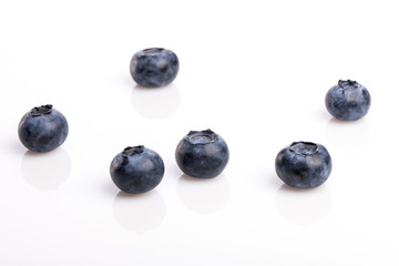 many blue berry on the wood table, whitebackground.