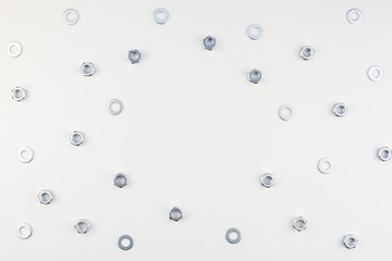Flat lay of metal nuts on white background
