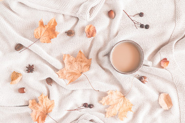 Autumn cozy composition. Cup of coffee, plaid, dried leaves. Autumn, fall concept. Flat lay, top view