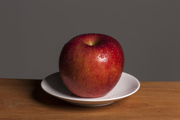 fresh fruits(red apple) on the wood table, grey background.