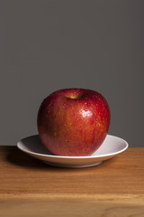 fresh fruits(red apple) on the wood table, grey background.