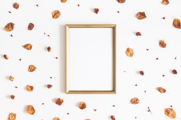 Autumn composition. Photo frame, dried flowers and leaves on white background. Autumn, fall concept. Flat lay, top view, copy space