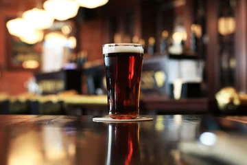 Türaufkleber Glass of cold dark beer on the background of the bar © Zarya Maxim