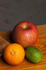 many variety fruits on the wood table, grey background