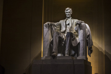 Abraham Lincoln statue at night inside the Lincoln Memorial