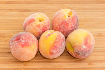 Fresh peaches on a wooden surface