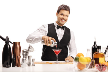 Bartender pouring his signature cocktail in a glass